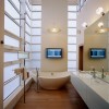 20 Marvelous Contemporary Bathroom Designs: Small Bathroom Interior Design Outfitted With Metal Chrome Free Standing Bathroom Towel Rack And Flat Screen TV On The Wall With Incredible Lighting Ideas