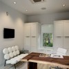 Dazzling White Office Designs Talks About Clear Interior: Modern Home Office Decorating Ideas With Adding Contemporary Armless Sofa And Rustic Wood Desk As Well As Flat Screen TV On The Wall And Ceiling Mounted Air Conditioner
