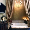 Enchanting Bathroom Design High Quality and Value to Your Home Décor: Lavish Elegant In A Nook With The Dim Light Of Pretty Chandelier And Lavish Bathtub Framed By Wooden Storage Underneath It And Covered By Huge Curtain In Elegant Brown Tone