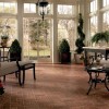 Alluring 10 Brick Floor Design For Unusual Interiors: Appealing Brick Flooring With Elegant Armchairs With Footstool And Black Round Table In Living Room With Classic Style