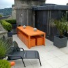 Living Under The Fascinating Rooftop Garden: Dazzling Rooftop Garden Design Furnished With Modern Dining Table And Dining Stools With Orange Colors As Well As Black Lounge Chair