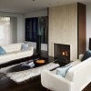 Inserting Clever Interior Ideas Into Delightful Living Room Designs: Fireplace And White Furry Rugs Plus Two Modern White Sofa And In The Contemporary Living Room Added With Eames Elliptical Cocktail Table
