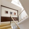 Enticing Staircase Landing Designs Applying Creative Ideas: Glass Staircase Railing With Artwork On The Wall For Contemporary Home Interior Designs