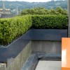 Living Under The Fascinating Rooftop Garden: Impressive Orange Dining Table And Green Plants Adorn A Breathtaking Rooftop Garden Design