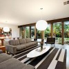 Eco-Friendly House Designs with Contemporary Style: Living Room Entertainment Center With Grey Sofas And Black White Area Rugs With Round Pendant Lamps Plus Eames Elliptical Cocktail Table