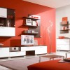 Captivated Living Room With Modern Interior Designs: White And Red Walls Embellish Extraordinary Living Room Design In Addition To Modern Wall Unit And Stainless Steel Coffee Tables Near Cosy Red Sofa