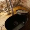 Enticing Work Space with Rustic Details in Barcelona: Black Vessel Sink On The Wooden Table With Rustic Wall