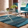 Appealing Coffee Glass Table With Contemporary Design: Chrome And Glass Coffee Table With Blue Shag Rugs Plus Comfortable Armchair And Wonderful Curtain Embellishing Modern Living Room Design