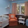 Fun Nursery Designs With Decorative Themes: Orange Armchair And Small Curtains Plus Blue Brown Walls As Well As White Baby Cots Adorning Nursery Design Ideas