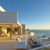 Breathtaking Contemporary Beach House with Perfect Architecture: Splendid Patio Decor Ideas Equipped With 4 White Armchairs With Pillows As Well As Fireplace With Beach Scenery