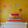 Lovely Interior Decorating Ideas Of Girls’ Bedroom In Attractive Themes: Cheerful Orange Girls Bedroom Interior Design With Colorful Bedcover And Cushion On A White Bed Frame And Pretty Wall Decorated By Floral Theme