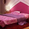 Lovely Interior Decorating Ideas Of Girls’ Bedroom In Attractive Themes: Dazzling Girls Bedroom Interior Decoration With Elegant Extended Headboard In White And Bold Purple Completed By Pretty Bedcover With Floral Motif