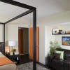 Enthralling Door Design to Greet and Welcome Your Guests with Impression: Endearing Private Bedroom With A Light Brown Door Equipped With A Comfy Lounge In A Nook And Ample Bed With Canopy In Black Frame