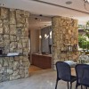 Attractive Exposed Stone Adorning Your Home Interior Design: Fascinating Modern Dining Space Decor With Dashing Exposed Stone Wall And Artistic Sculpture