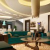 Magnificent Modern Round Coffee Table Designs for Living Room: Green Sofa And Enchanting Round Coffee Table With Dramatic Ceiling Design For Charming Living Room