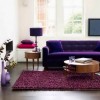 Magnificent Modern Round Coffee Table Designs for Living Room: Round Wood Coffee Table With Storage Plus Purple Sofa Also Purple Rug For Excellent Living Room