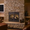 10 Astonishing Stone Fireplaces Brings Nature Materials at Home: Stone Fireplace Decor Ideas And Flat Screen TV Plus Leather Armchair Footstool